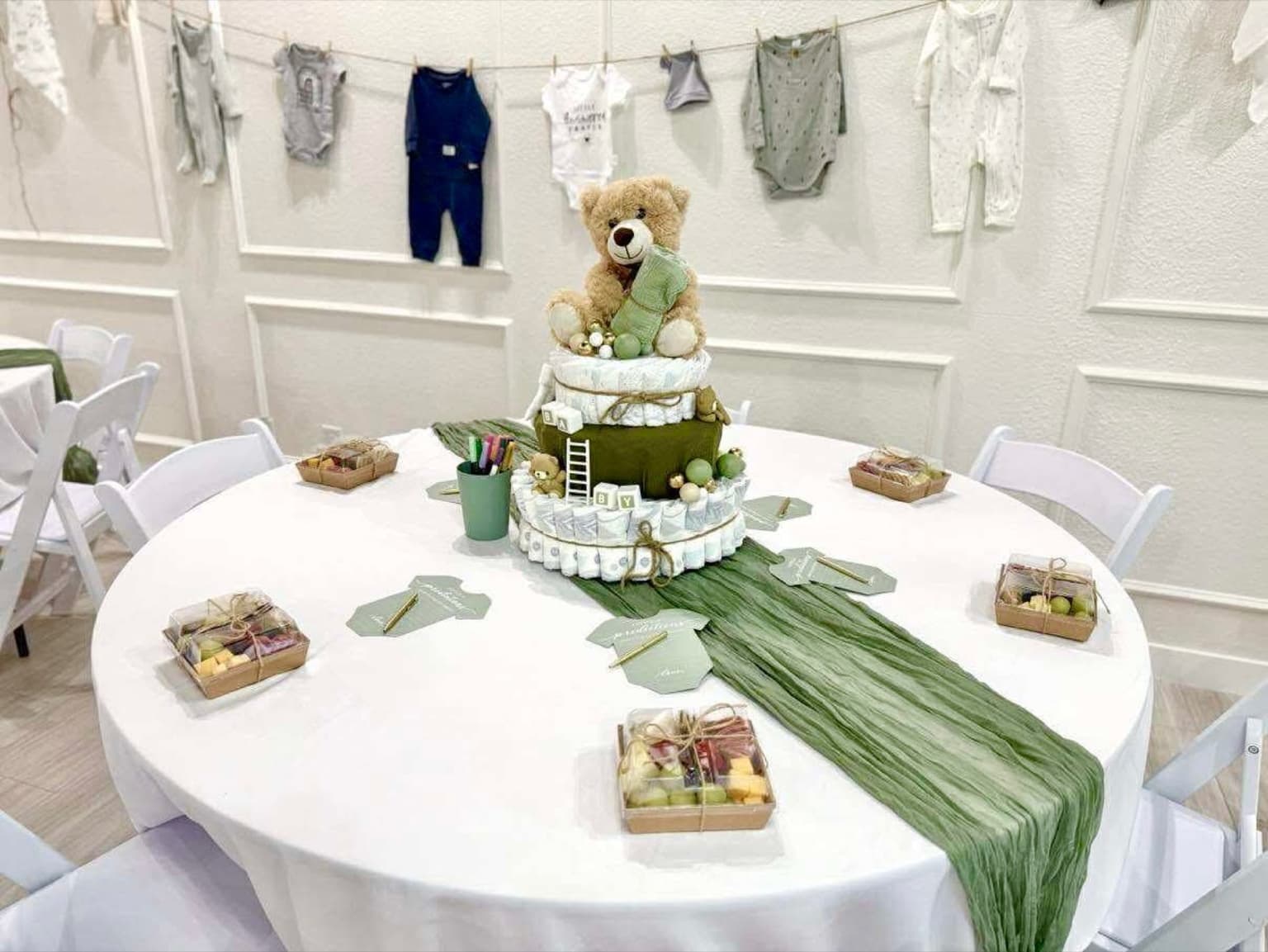 Round baby shower table with teddy bear diaper cake centerpiece at Aramas Events