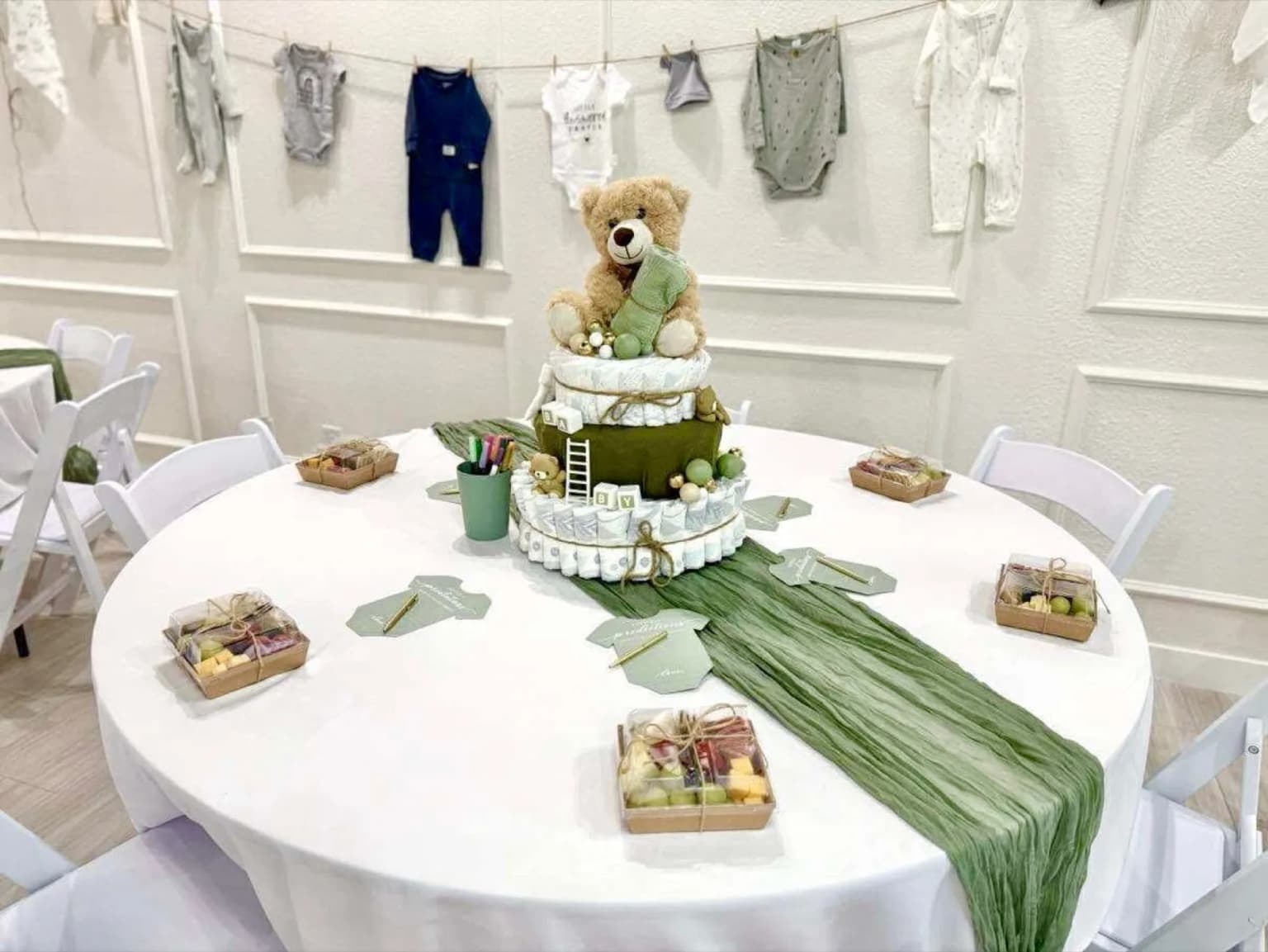 Round baby shower table with teddy bear diaper cake centerpiece at Aramas Events