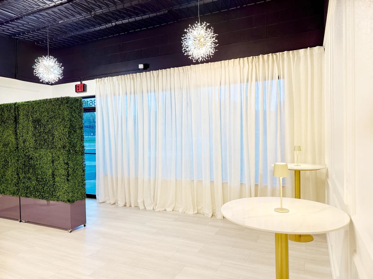 Curtained event backdrop and front room setup at Aramas Events